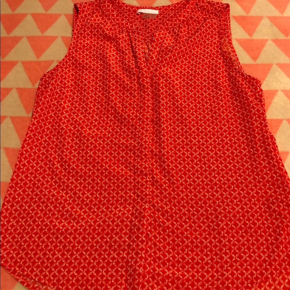 Red sleeveless top with white cross cross pattern